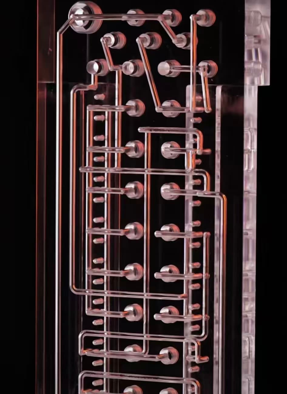 Backlit multi-layer acrylic microfluidic manifold with serpentine channels and high-density fluidic ports