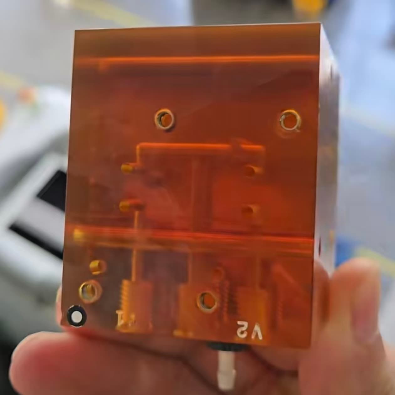 Amber translucent PEI diffusion bonded microfluidic manifold with internal channels and threaded ports